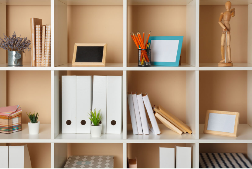 White cabinet with storage cubes, decorations, and trinkets