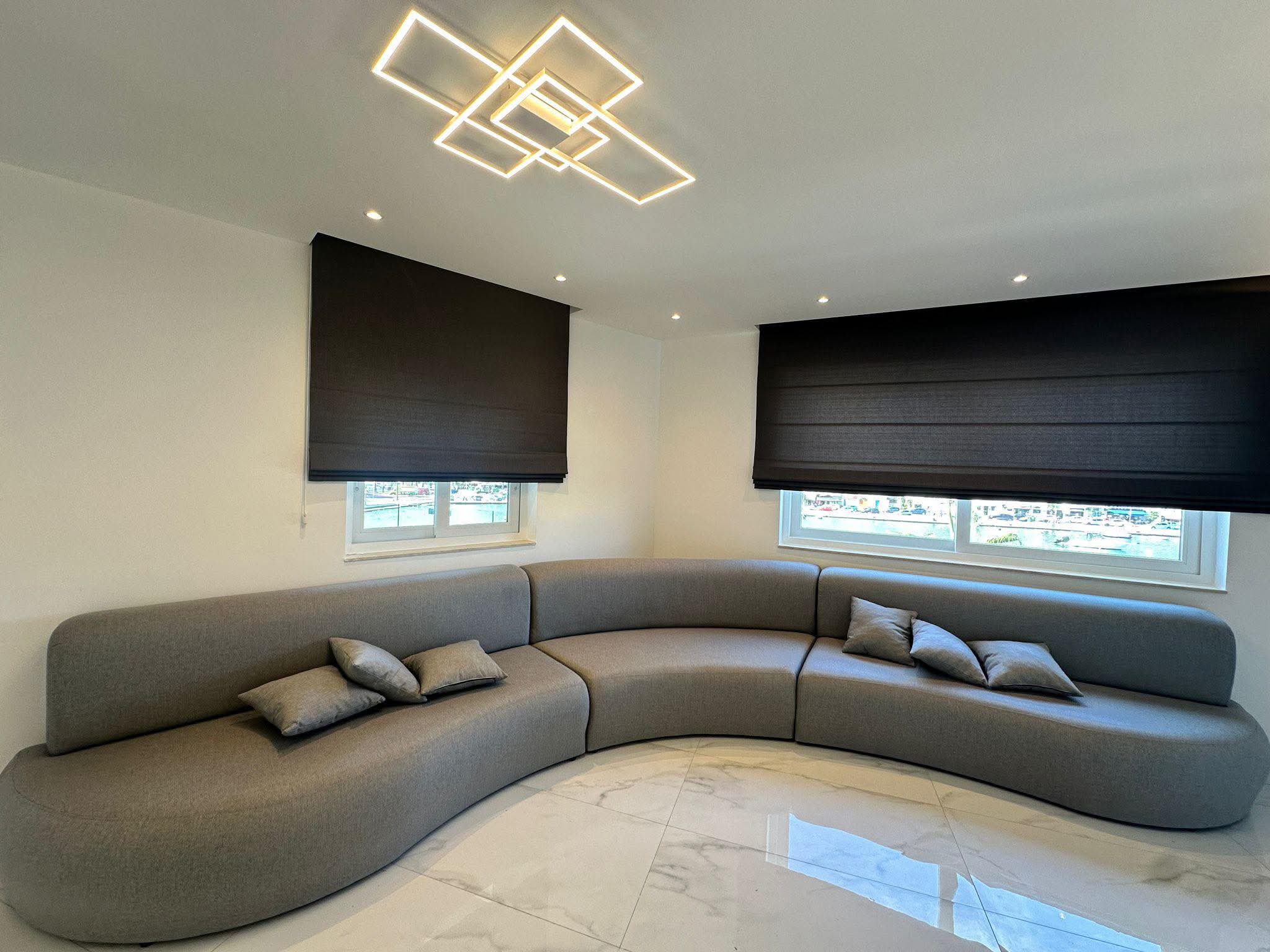 Neutral lounge with layered cushions and throws