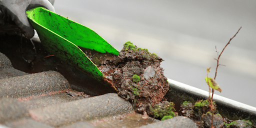 gutter-cleaning-scoop-with-mud-inside-gutters-png