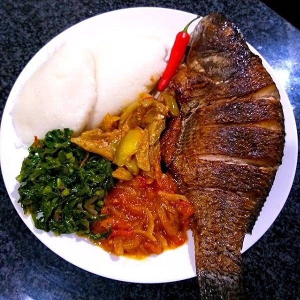 Nshima with relishes and grilled tilapia