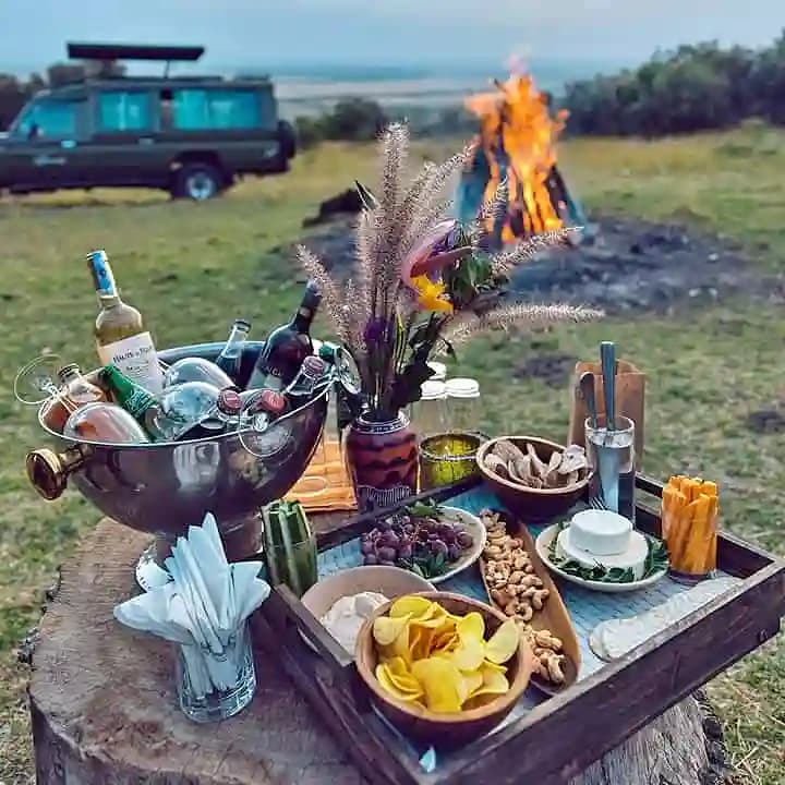 Sundowner drinks overlooking the Maasai Mara at golden hour
