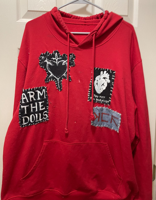 red hoodie witha few patches