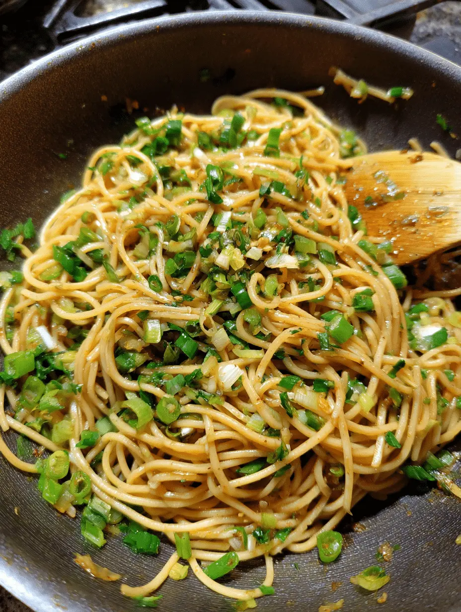 Close-up of ginger scallion noodles in a bowl, topped with sliced scallions and sesame seeds, served as a quick Asian-inspired meal.