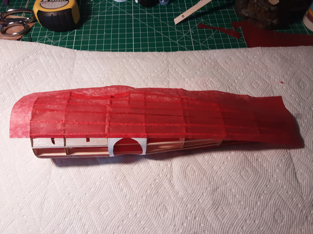 Covering the other side of the fuselage. It's really easy on a Dr.1. It gets a bit more complex with other models that have a tapered cone fuselage.