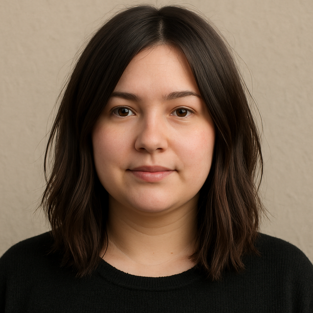 A woman with a round face wearing a textured long bob (lob) that hits two inches below the collarbone.