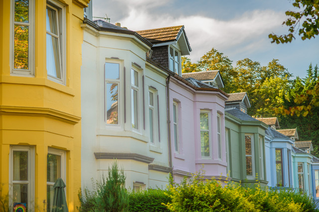 Colourful pet-friendly houses on a leafy residential street in Glasgow, Scotland &ndash; ideal homes for international buyers moving with pets.