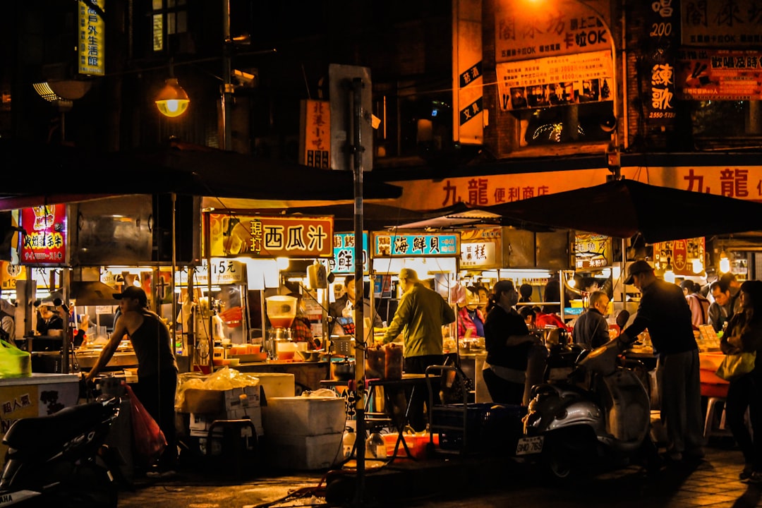 Pojangmacha street stall at night in Seoul with anju snacks including tteokbokki and eomuk, orange tent glowing
