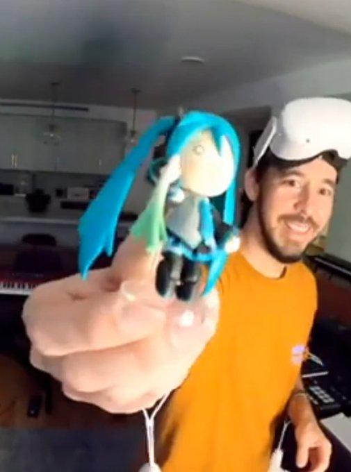 Mike Shinoda holding Hachune Miku