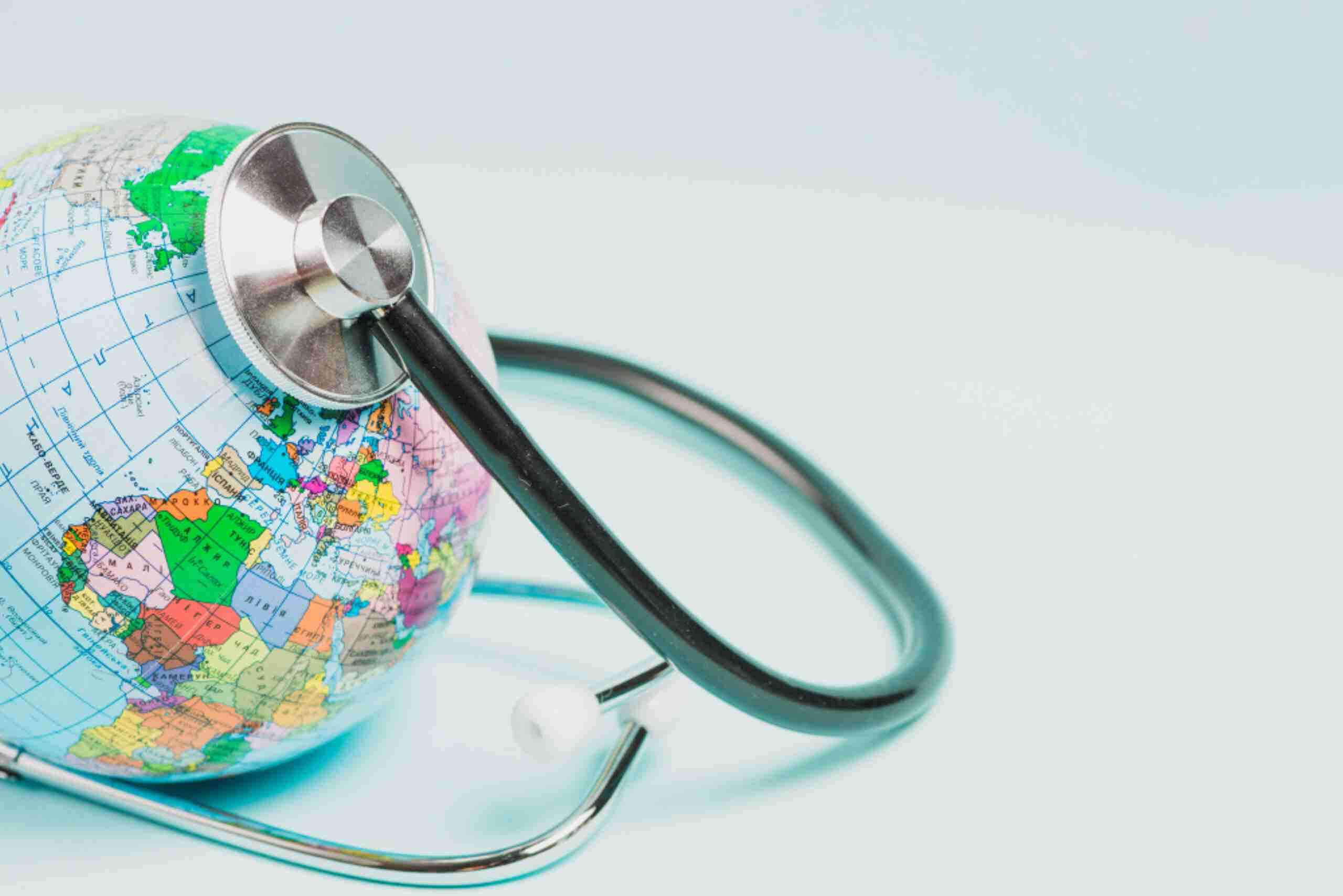 An image showing a globe with a stethoscope, representing the link between travel and health.