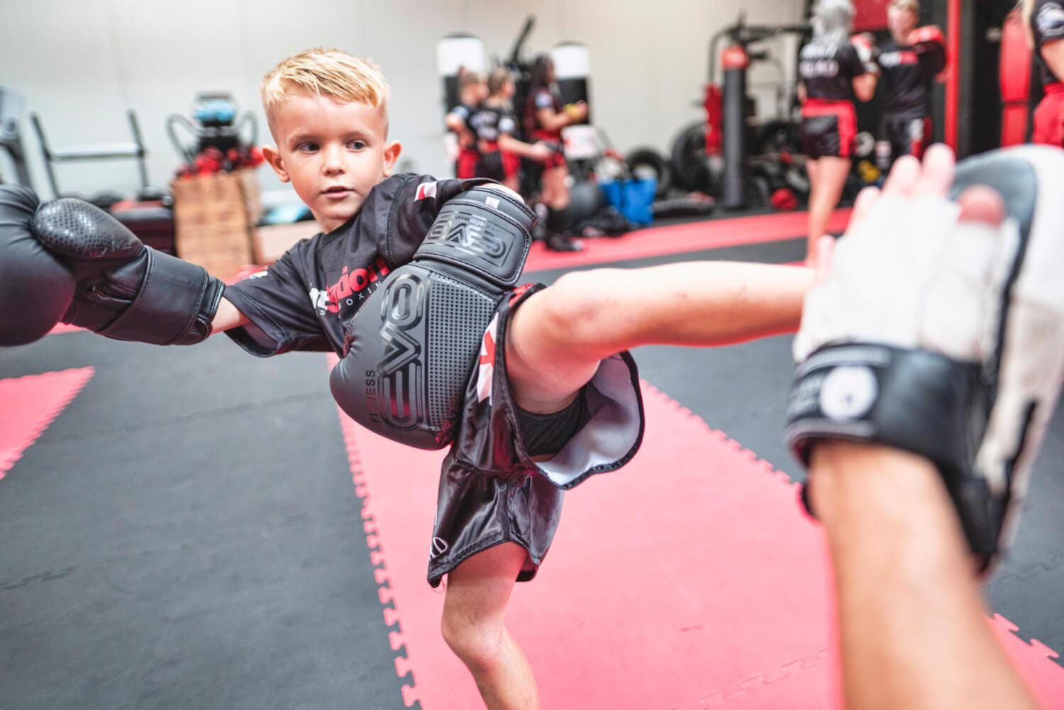 A young Fight Station member throwing a kick during training