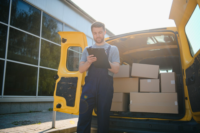 delivery men unloading moving boxes from car.jpg