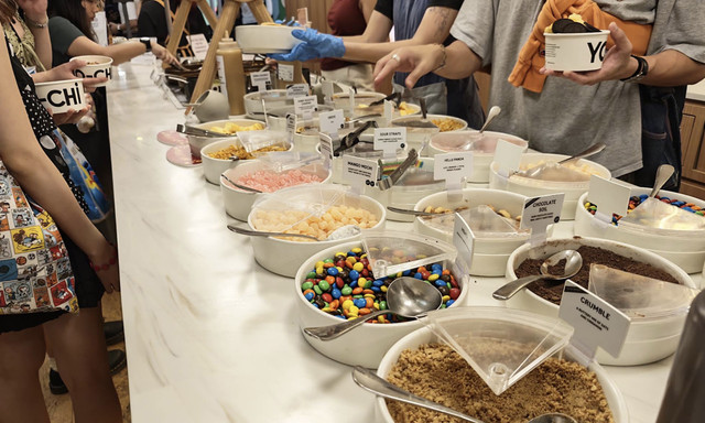 Self-serve toppings bar at YO-CHI Orchard Central with a variety of sweet toppings