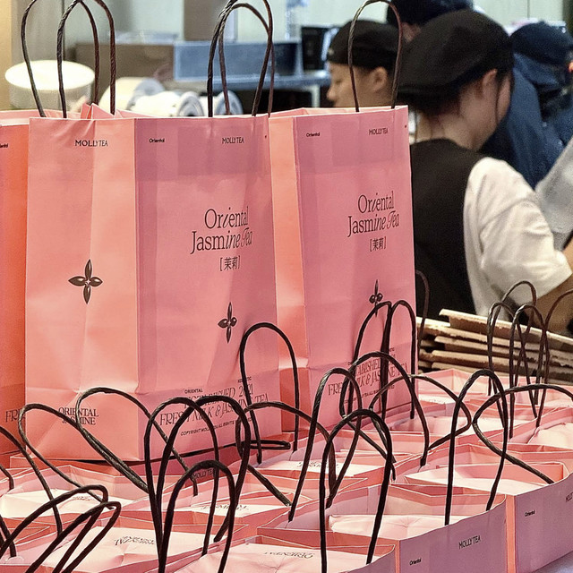MOLLY TEA branded pink shopping bags at Orchard Central