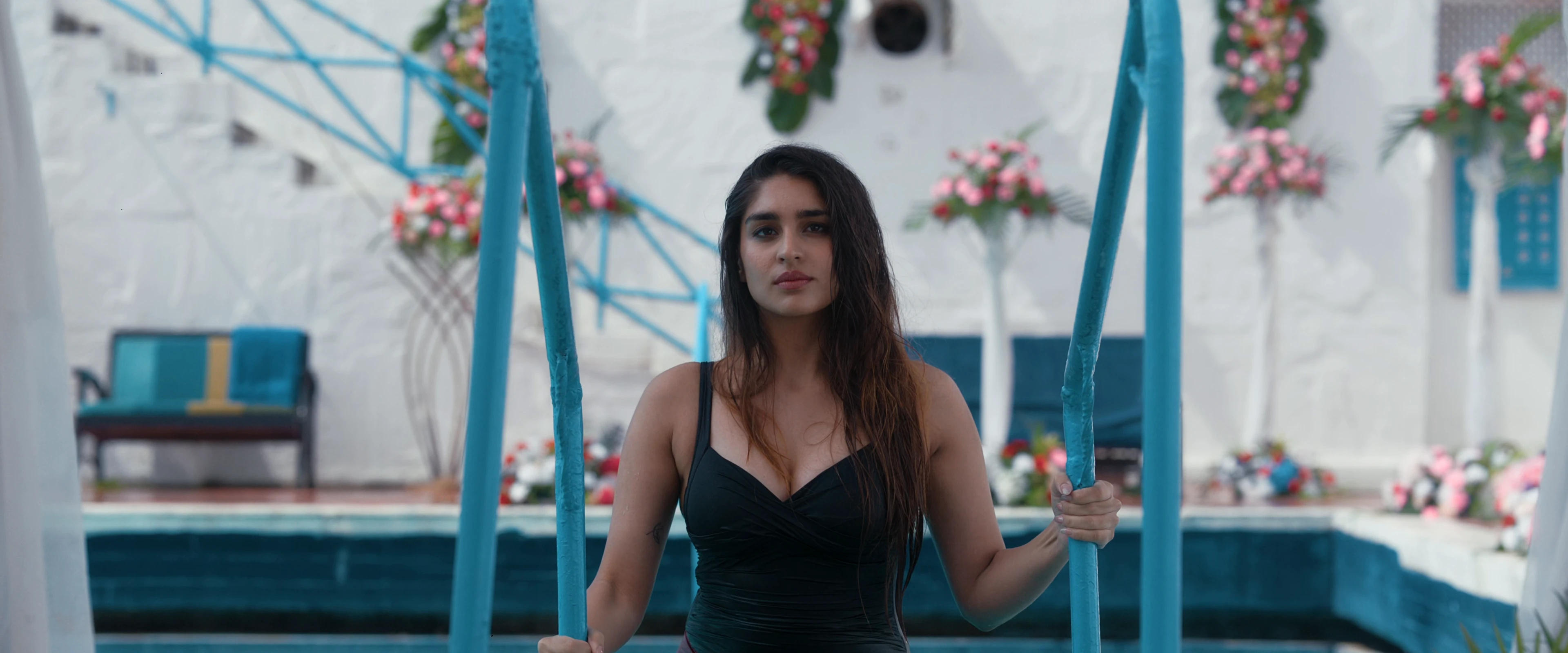 Yukti Thareja posing in a black plunging neckline swimsuit for KJQ movie photoshoot.