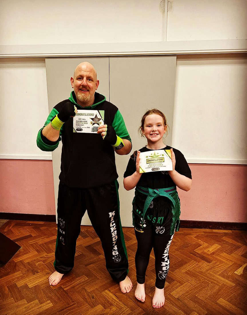 A parent and child together at MACK Kickboxing