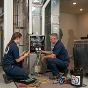 Technician performing HVAC maintenance