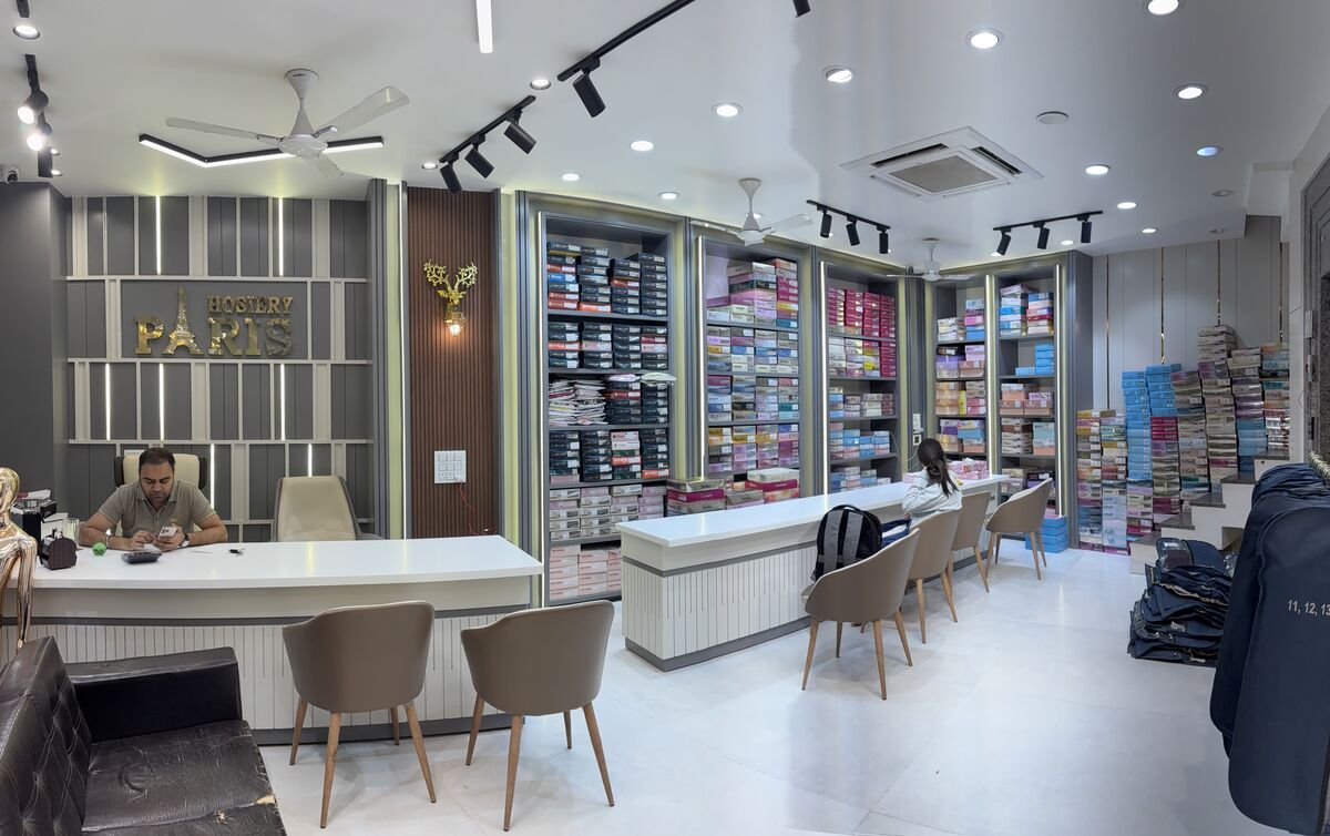 Front desk at the Paris Hosiery store with the gold Paris Hosiery sign in the background