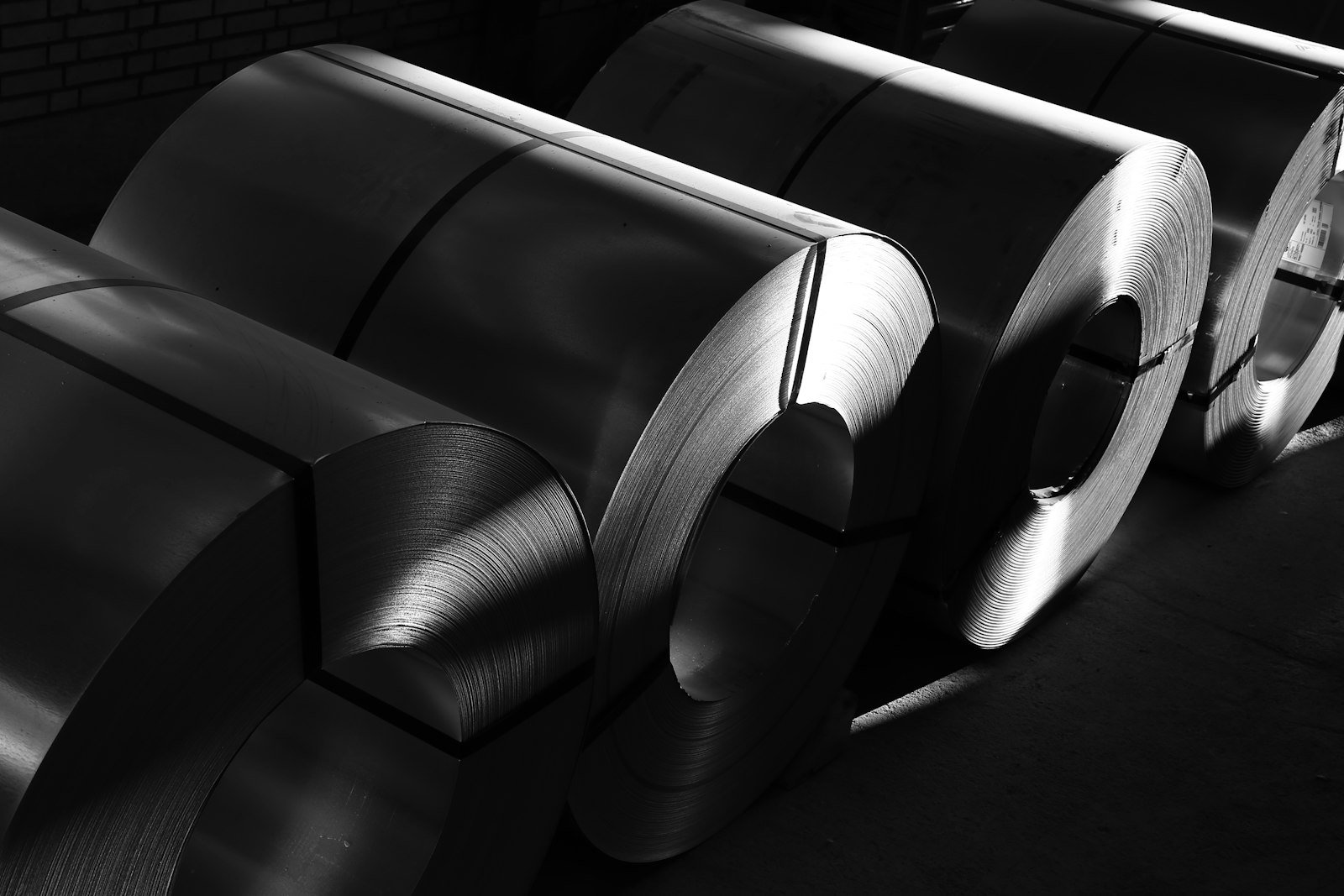 Titanium and metal sheet coil rolls in industrial production facility - raw material input for cookware stamping and forming