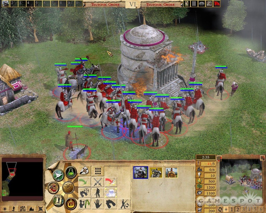 Medieval Empire Earth II cavalry and infantry surrounding a large building during a siege.