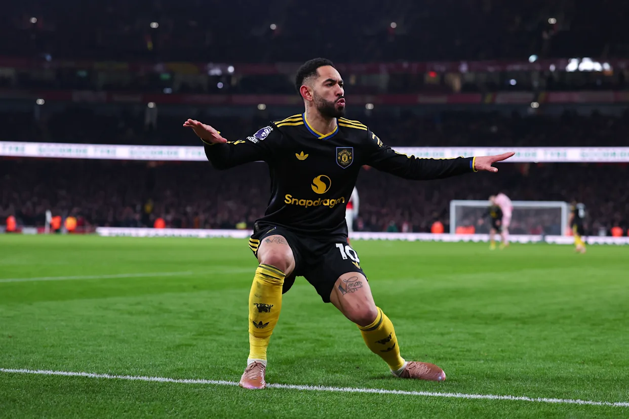 Manchester United players celebrating a goal at the Emirates Stadium