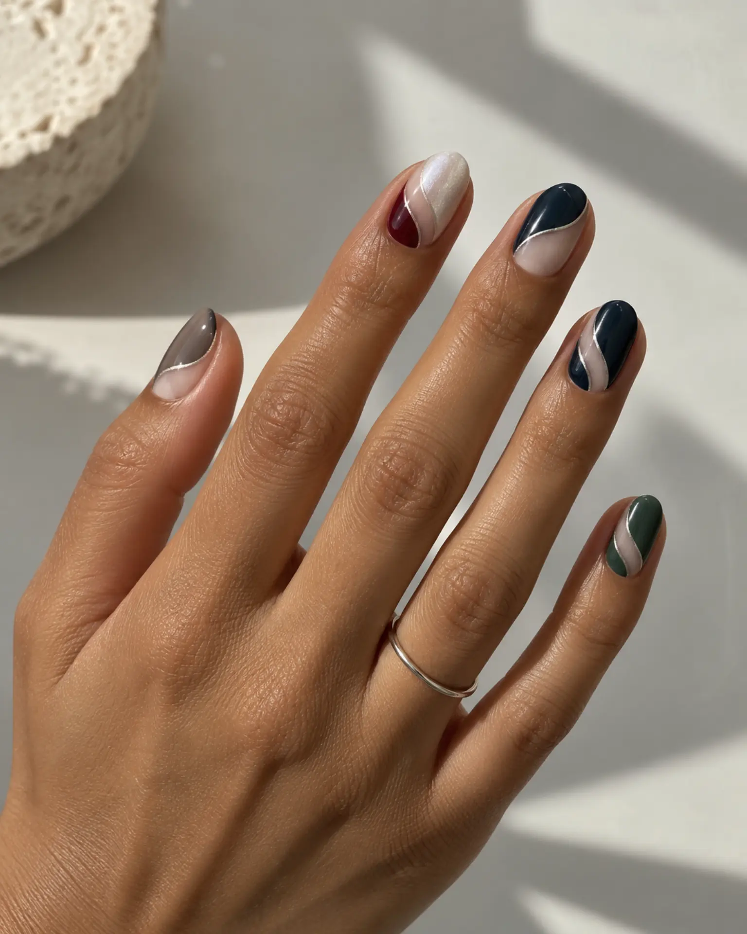Winter Negative-Space Curve manicure inspiration for winter nail ideas