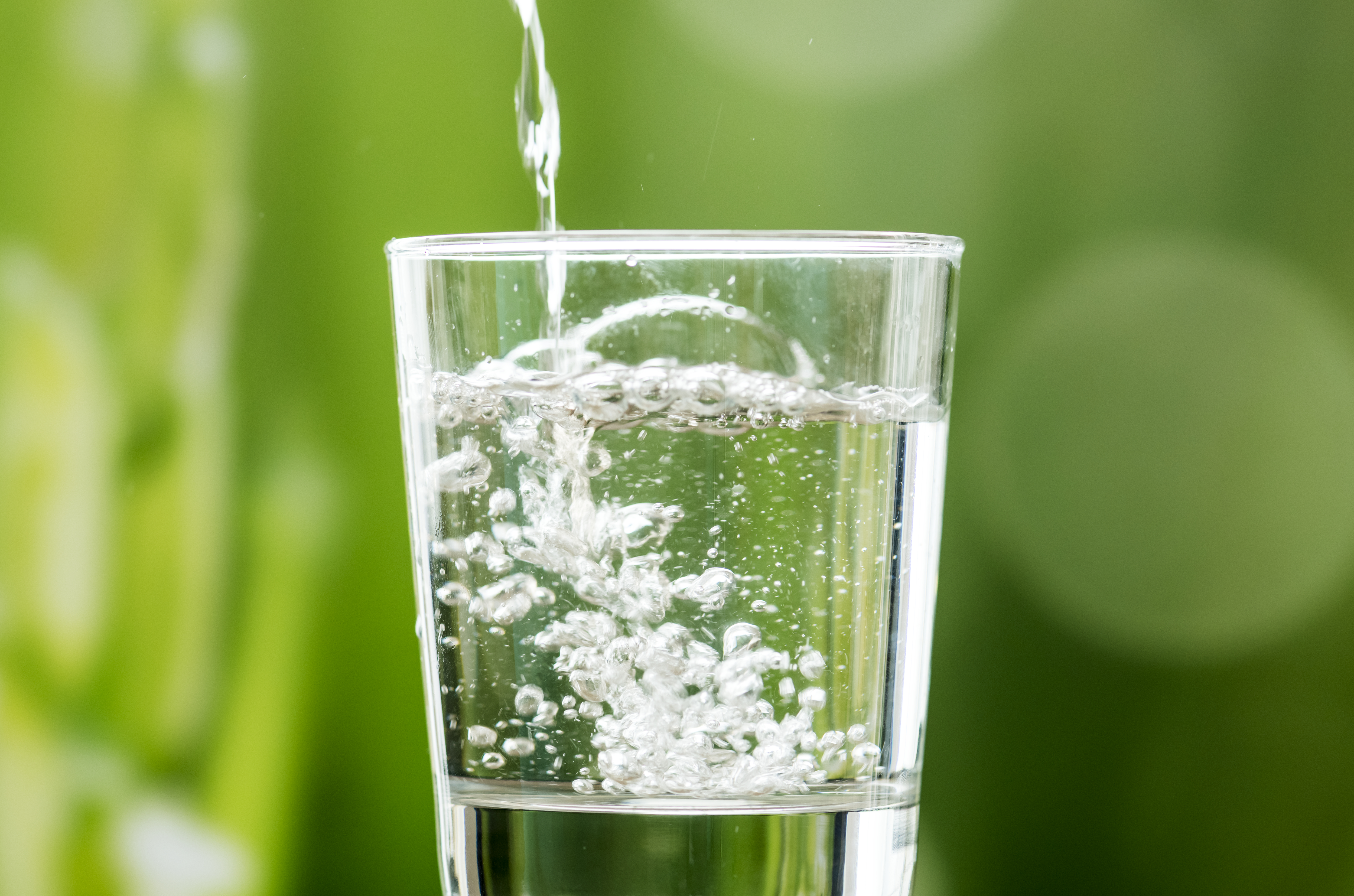 water pouring from bottle into glass