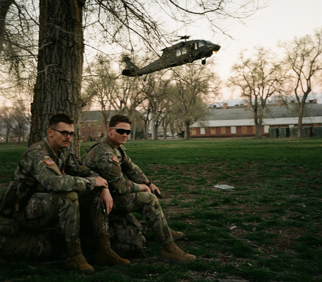 Army National Guard SMP cadet with a UH-60 Blackhawk behind him
