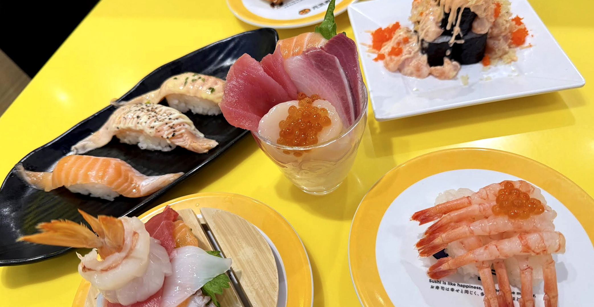 Sushi plates on conveyor belt at Genki Sushi