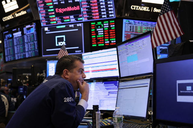 Photorealistic photojournalistic image of a Wall Street trader watching multiple stock market monitors on a busy trading floor, documentary