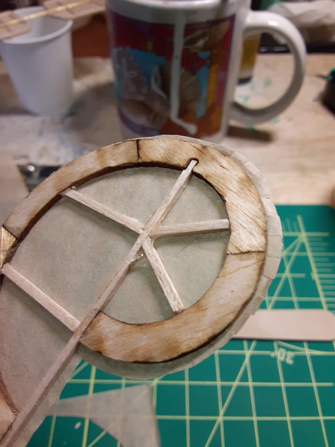 The rudder. Apply the glue-water mix with a brush on both the tissue and the balsa. Using a finger dampened with water, fold the overlap over the balsa.