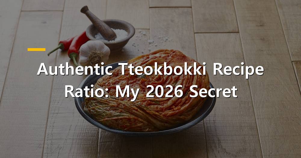 A steaming bowl of authentic tteokbokki with chewy rice cakes and fish cakes in a rich red sauce