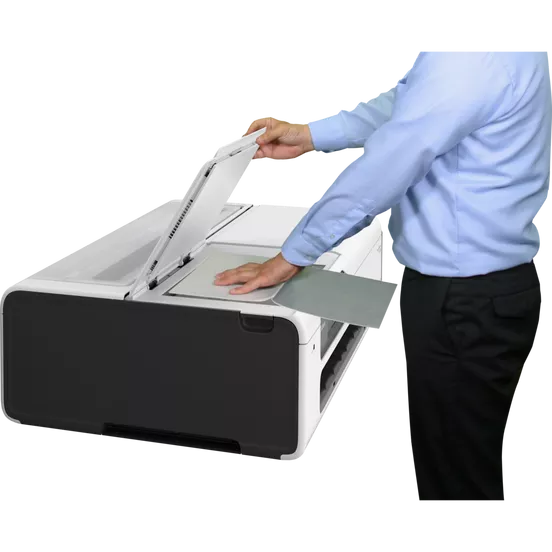 Man placing document on Canon imagePROGRAF TC-21M scanner for copying or scanning task