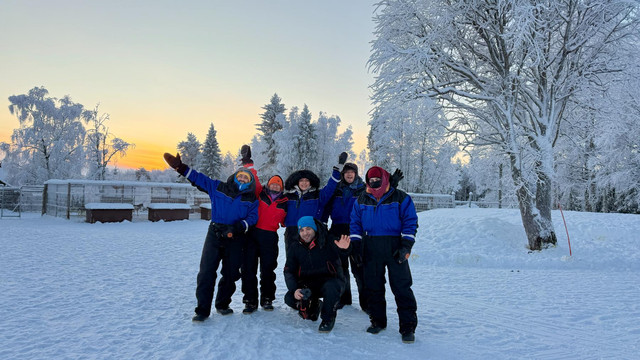 The group in Arctic gear at sunset in Finnish Lapland