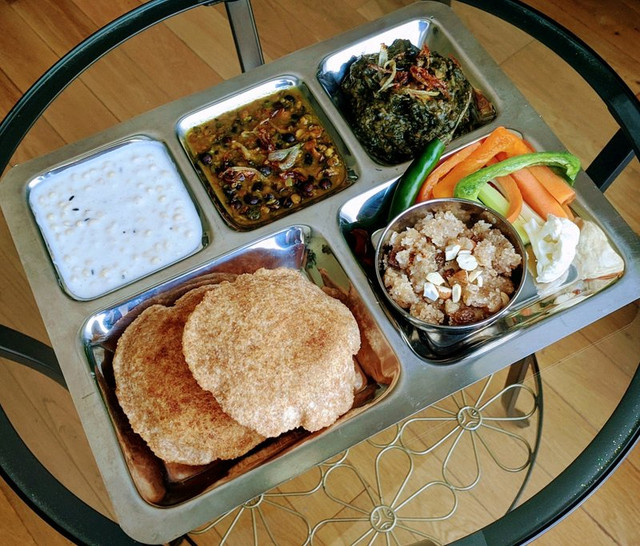 Boondi raita, kala channa, saag, puri, suji ka halwa, and salad.