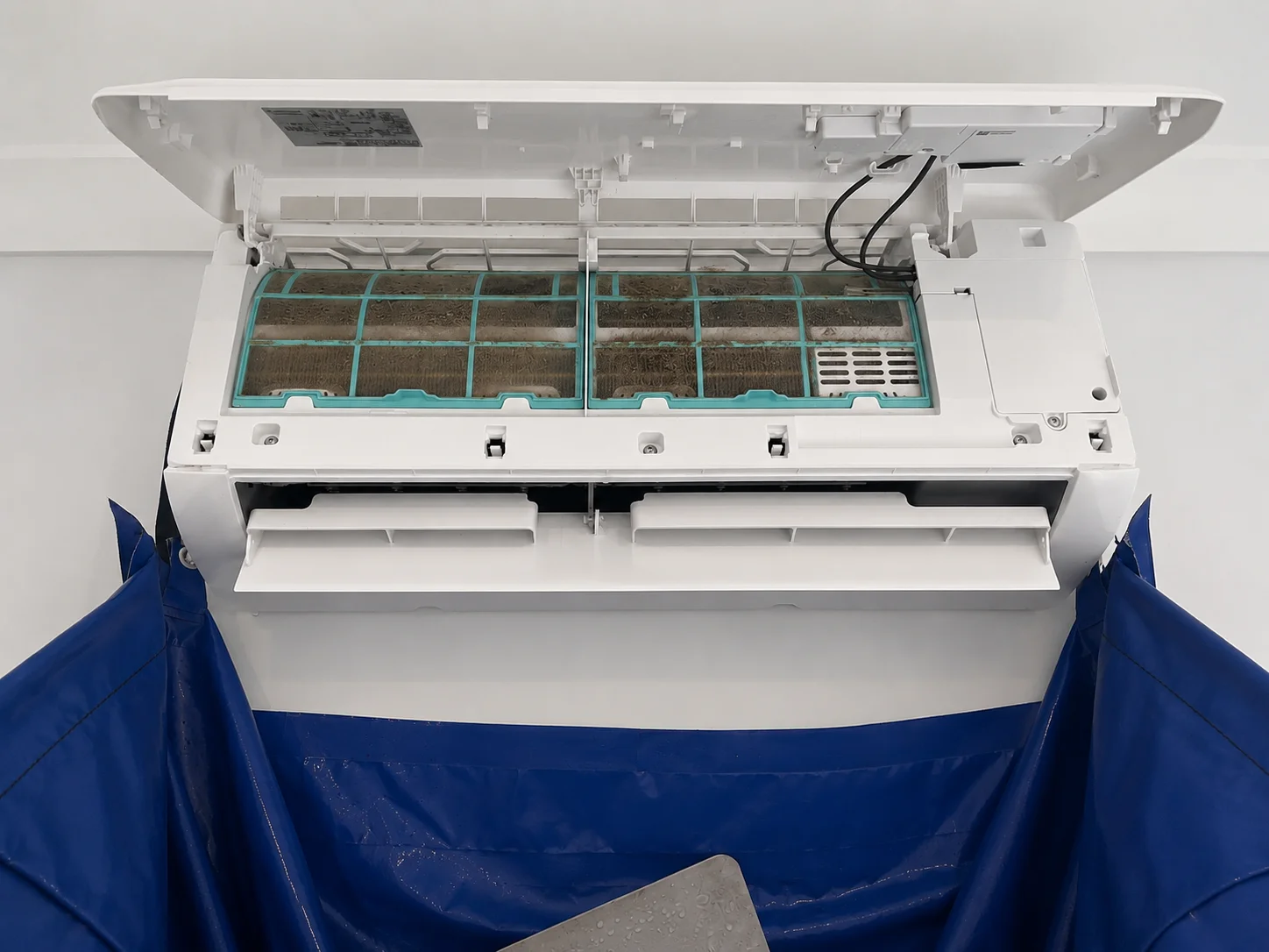 The same air conditioner after a professional deep clean, looking spotless