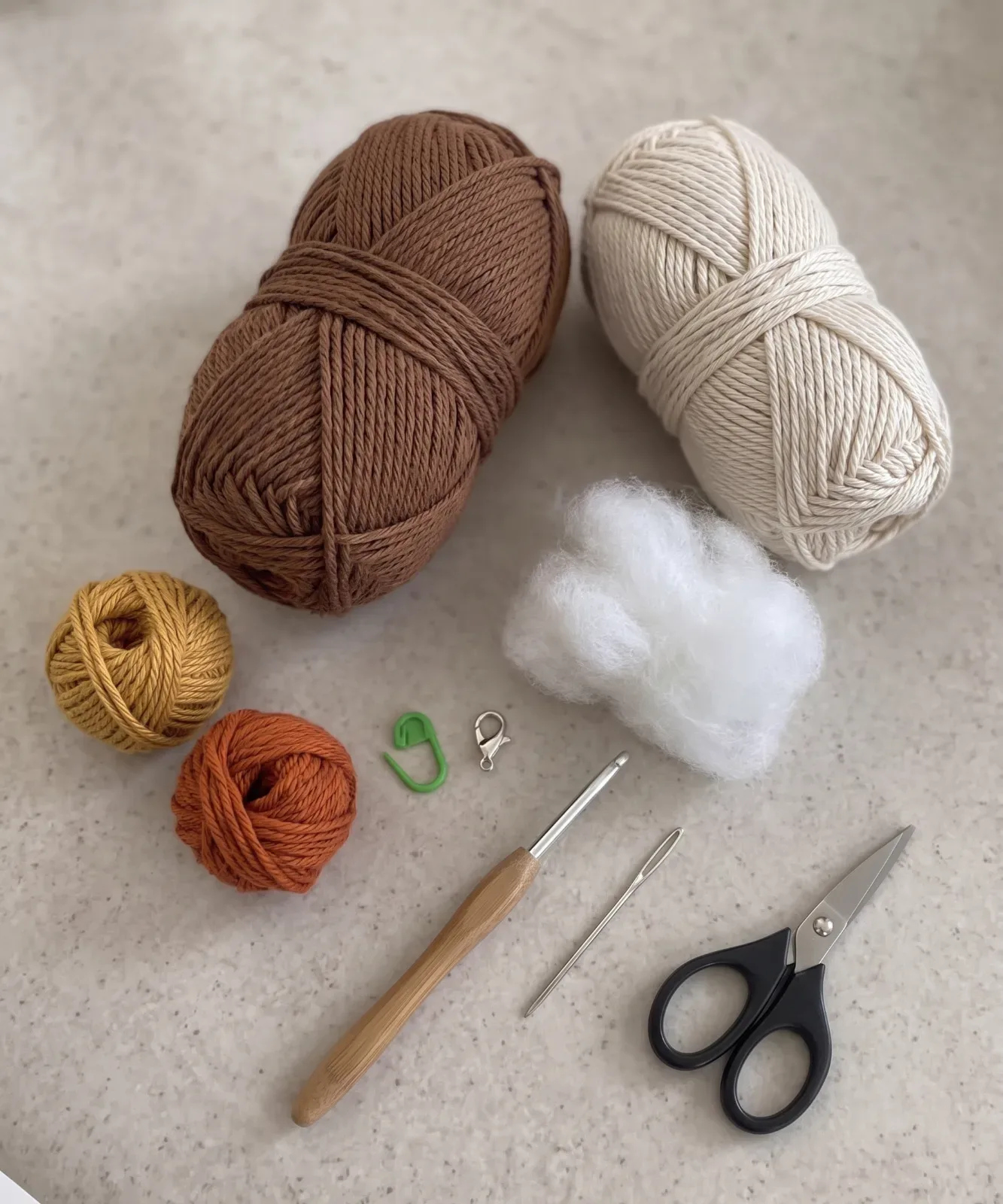 Brown, cream, mustard, rust, and orange yarn with crochet hook, stuffing, needle, marker, and scissors for the turkey ornament