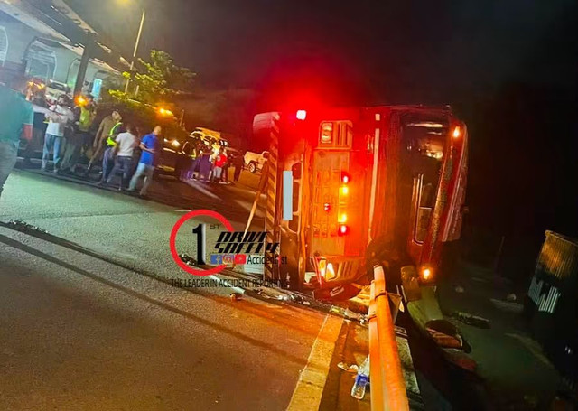A Primemover overturns with its container on the Colombo harbor entrance road.
