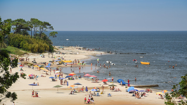 Midday scene of Atlantida, Uruguay, featuring relaxed coastal living, local charm, and affordable housing ideal for families relocating on a budget
