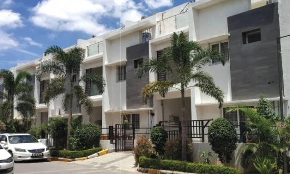 Luxury triplex villa architectural front elevation inside Vertex Kingston Park community in Nallagandla Hyderabad