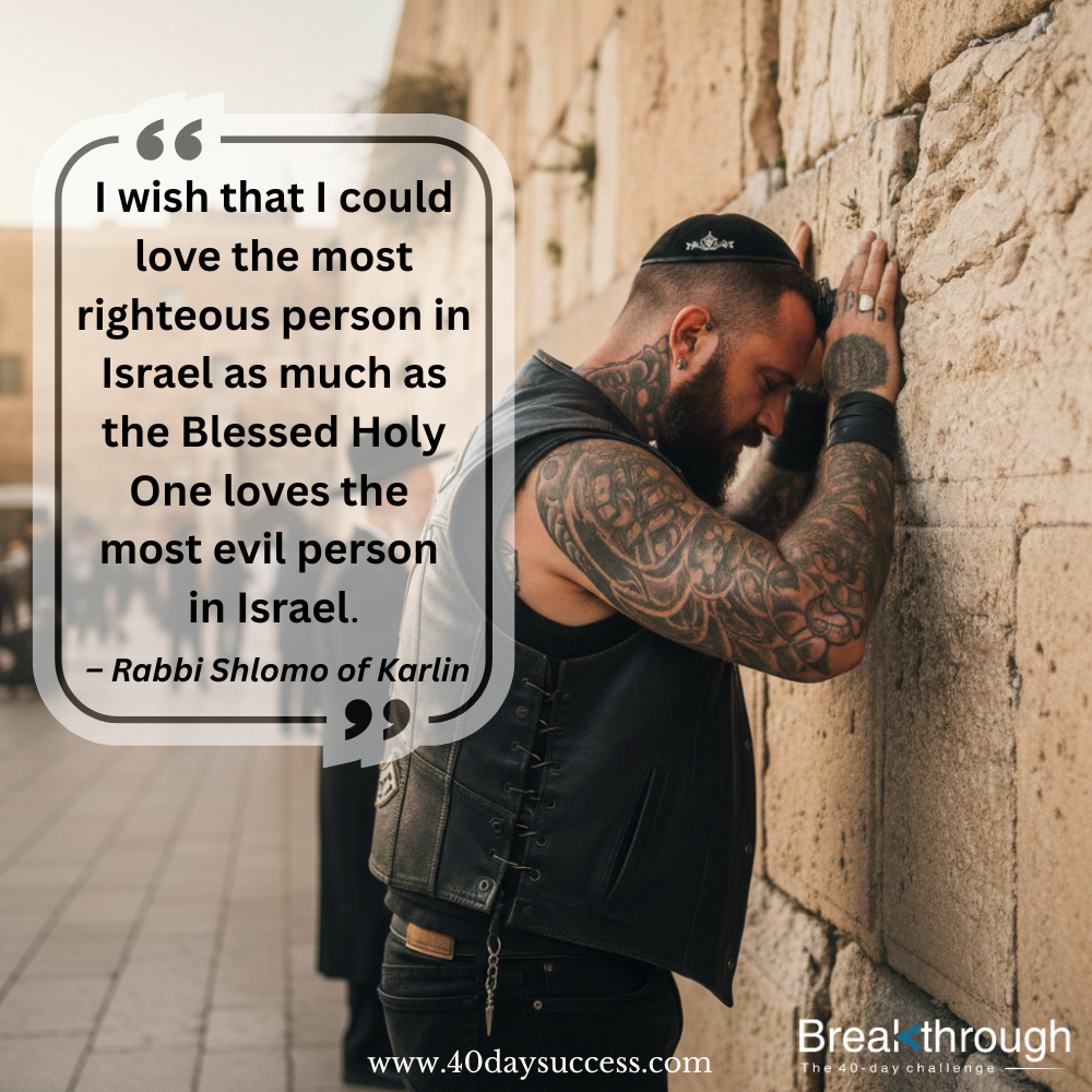 A tattooed Jewish man leans against the Western Wall beside a Rabbi Shlomo of Karlin quote on Divine love.