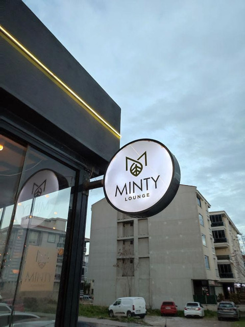 Lit cabinet sign on commercial building at night