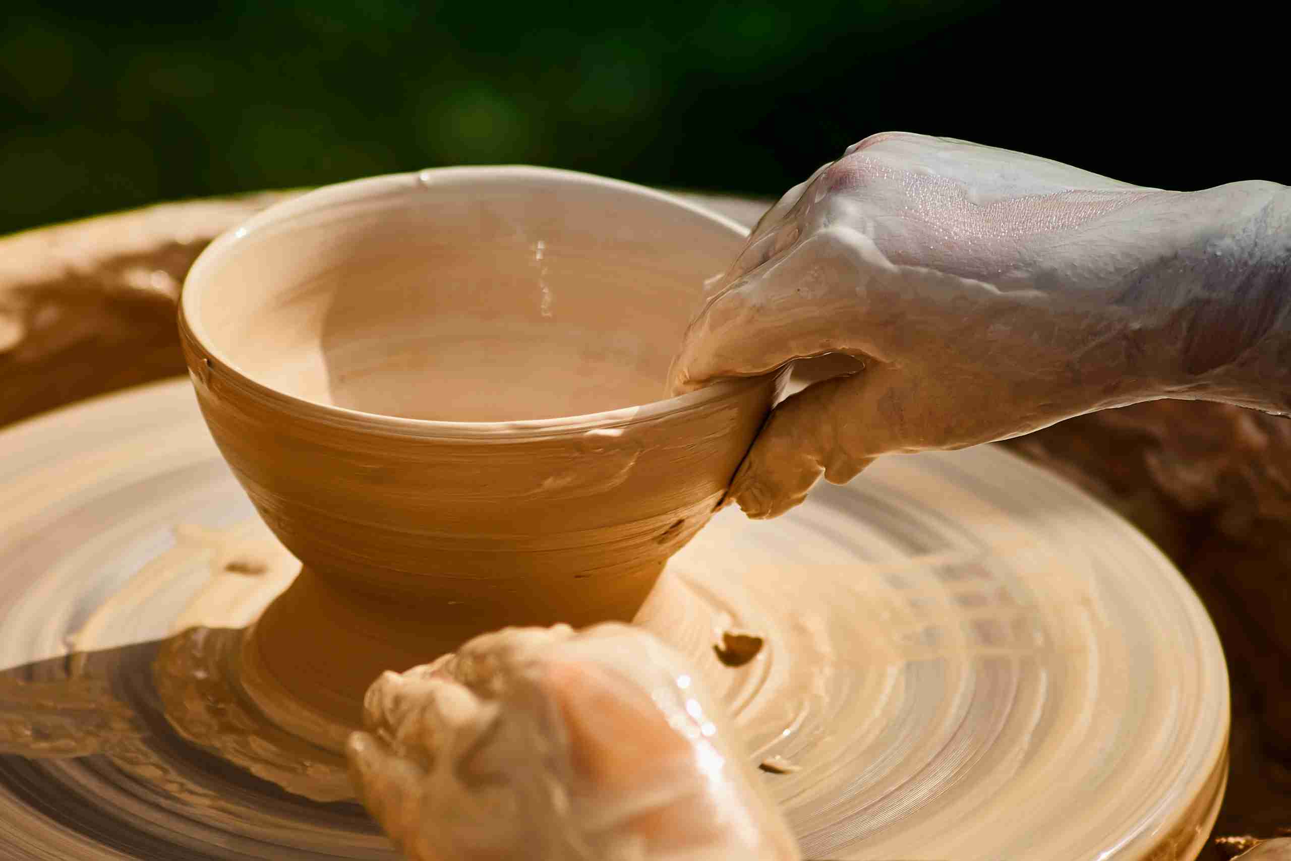 An image showing a pottery bowl on a pottery wheel.