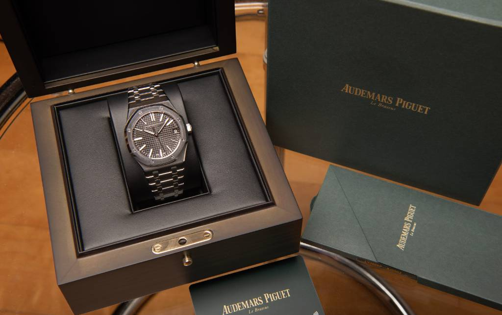 Luxury watch box, warranty card and papers laid out together