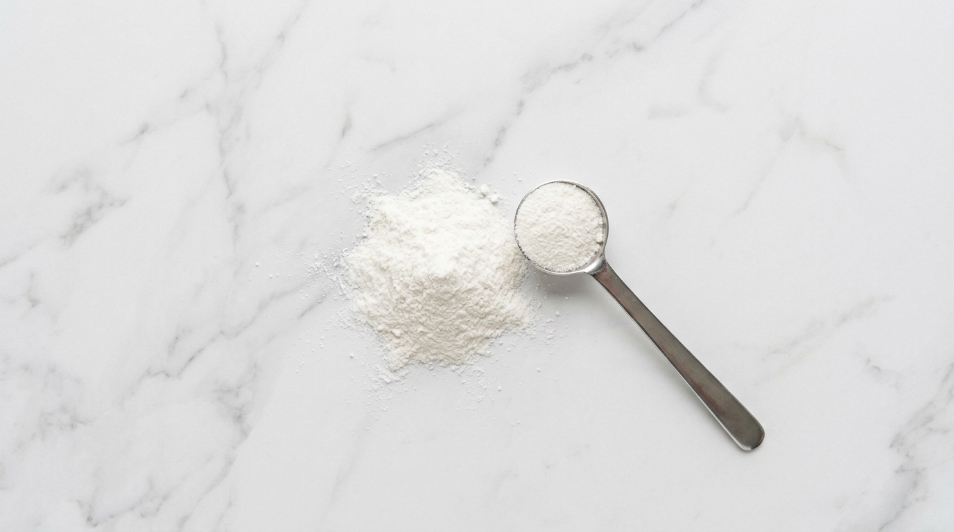 White supplement powder measured on a marble surface