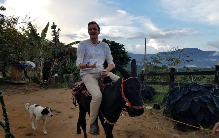 Richard Bertossa on a donkey in a rural setting