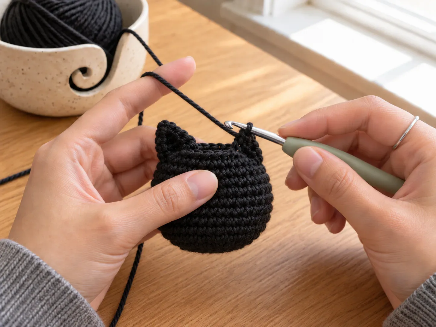 Form the ears — Shape the two small pointed ears directly from the top edge without sewing separate pieces.