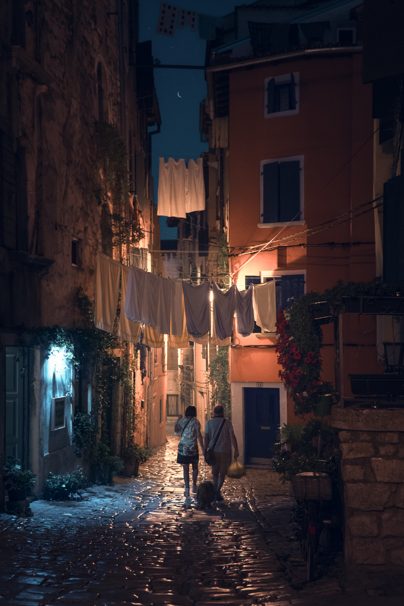 The finished Croatia edit — a warm, lamp-lit alley in Rovinj at night, washing strung overhead