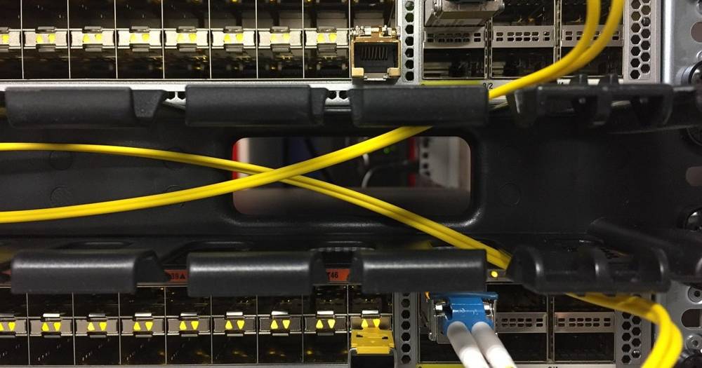 Technician working on a server rack, symbolizing web hosting support.