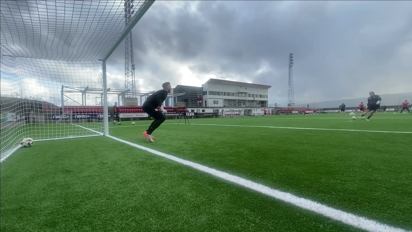 Goalkeeper pushing off sideways in his goal during a footwork session