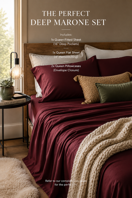Moody maximalist bedroom with burgundy sheets